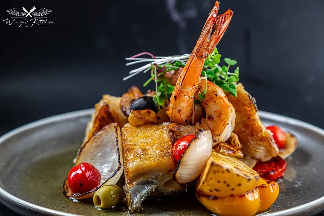 A large Wagyu tomahawk steak grilled to perfection on a wooden board.